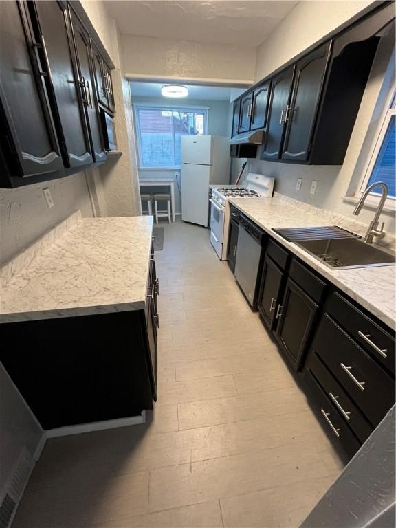 kitchen with white appliances and sink