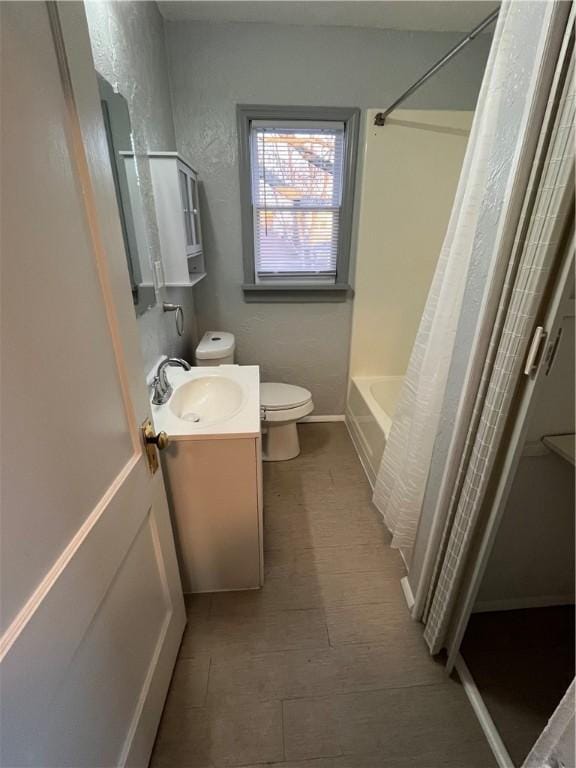 full bathroom with vanity, toilet, and shower / tub combo