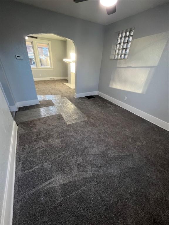 carpeted spare room with ceiling fan