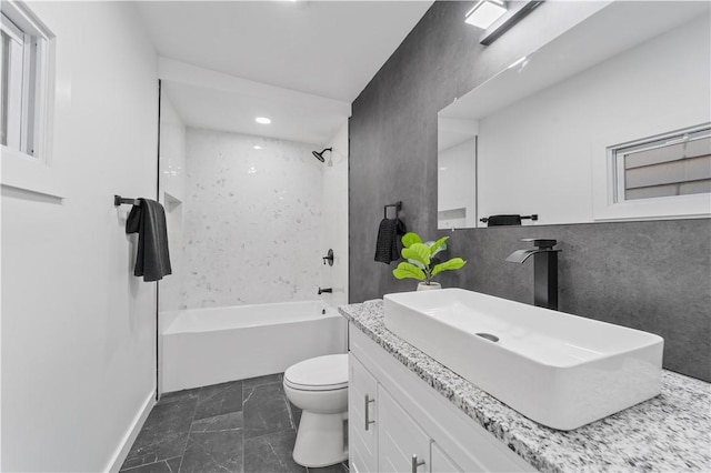 full bathroom with shower / bathing tub combination, vanity, and toilet