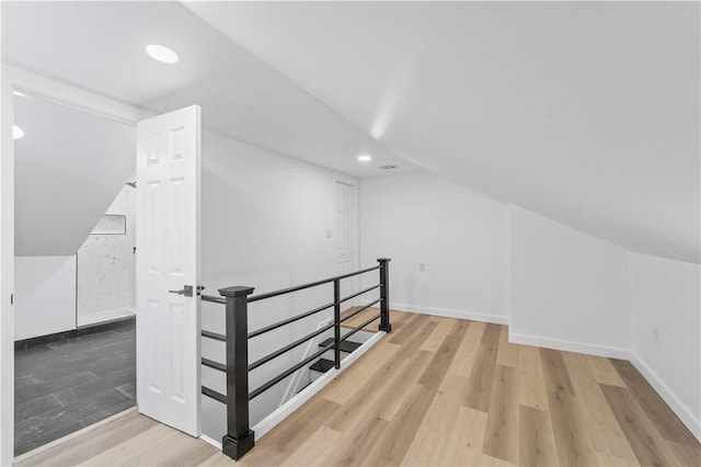 additional living space with lofted ceiling and wood-type flooring