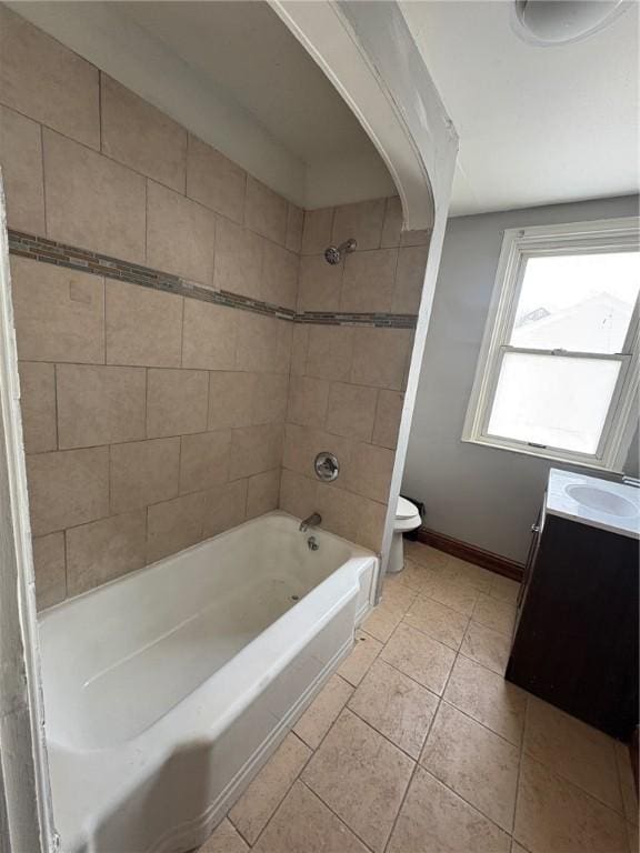 full bathroom with vanity, tile patterned flooring, toilet, and tiled shower / bath