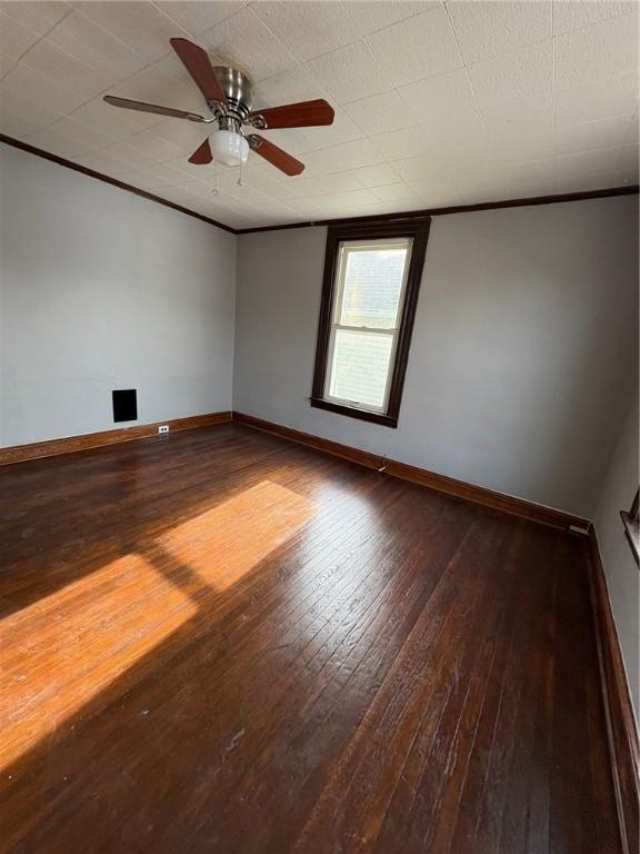 unfurnished room featuring ceiling fan, ornamental molding, and hardwood / wood-style floors