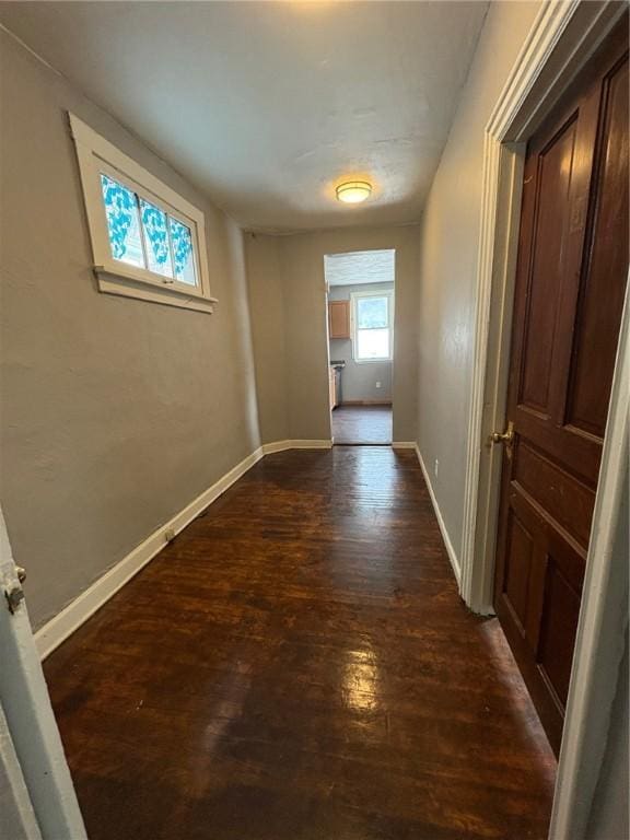 corridor featuring dark wood-type flooring