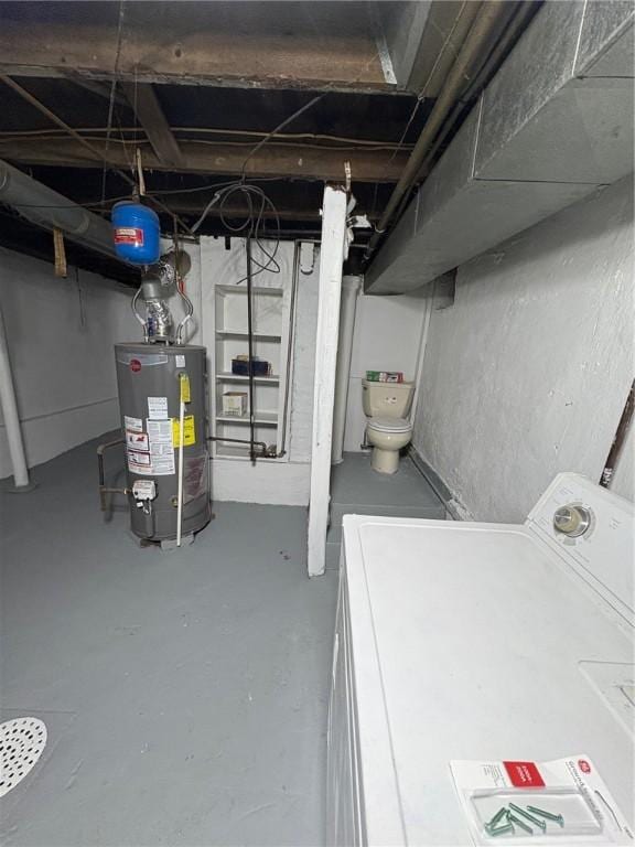 basement with gas water heater and washer / dryer