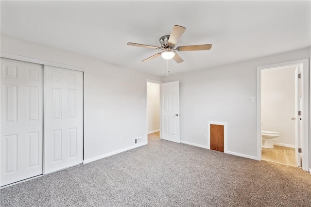 unfurnished bedroom with carpet flooring, connected bathroom, ceiling fan, and a closet