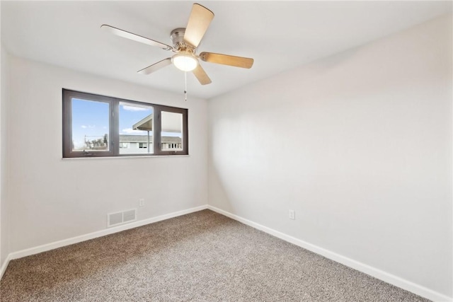 carpeted spare room featuring ceiling fan