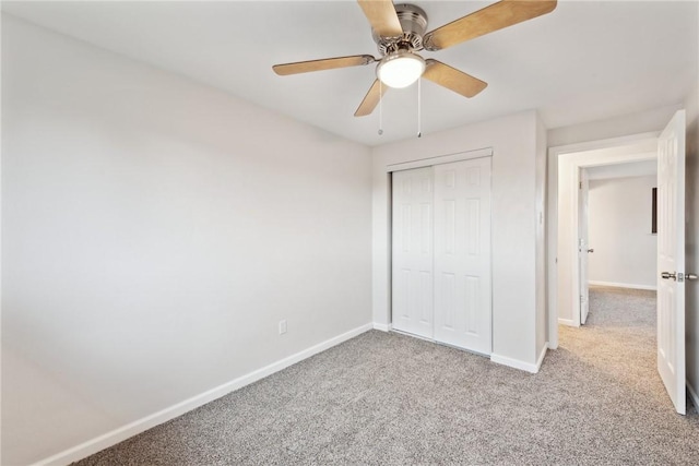 unfurnished bedroom featuring light carpet, ceiling fan, and a closet