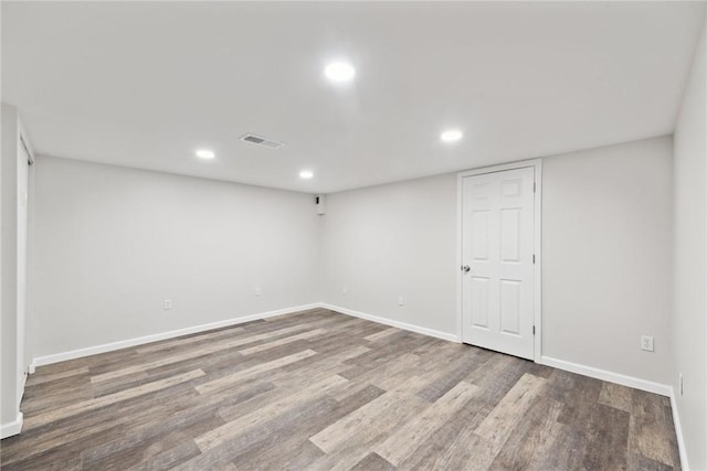 basement with hardwood / wood-style flooring