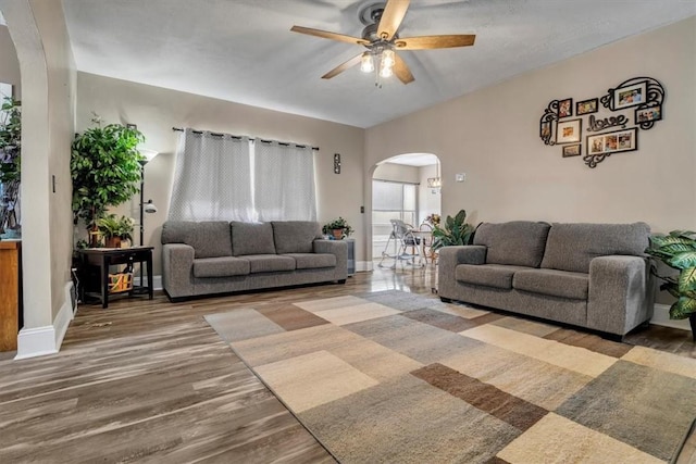 living room featuring hardwood / wood-style flooring and ceiling fan