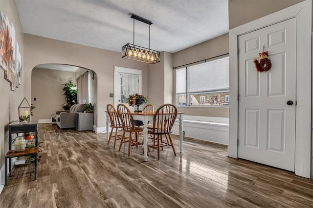 dining area with hardwood / wood-style flooring and a textured ceiling