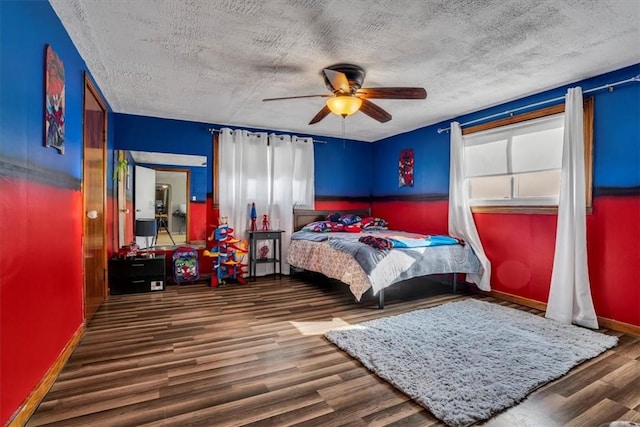 bedroom featuring wood-type flooring, a textured ceiling, and ceiling fan