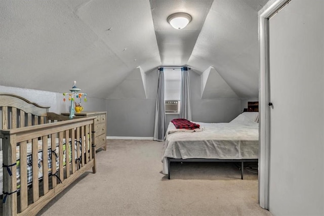 carpeted bedroom with vaulted ceiling, cooling unit, and a textured ceiling