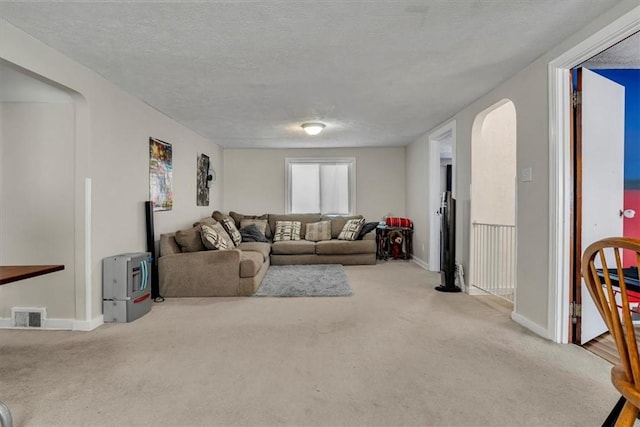 carpeted living room with a textured ceiling