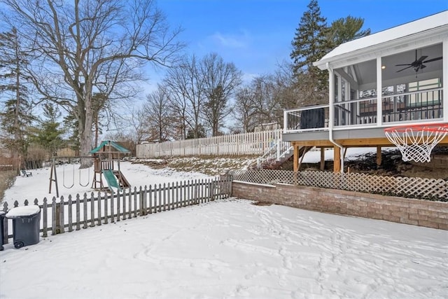 exterior space featuring a playground, a sunroom, and ceiling fan