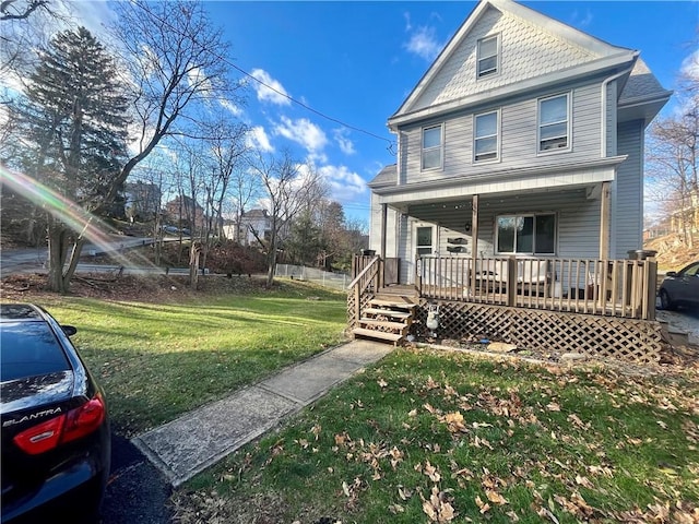 view of property with a front yard and covered porch