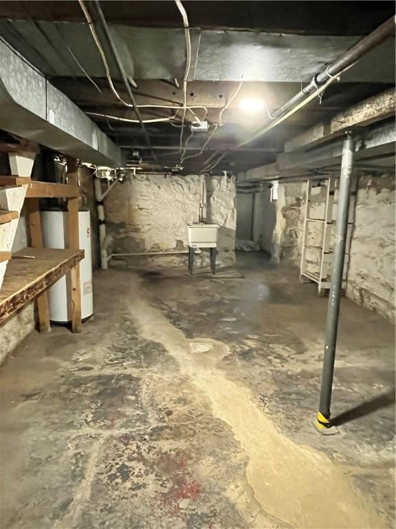 basement featuring sink and water heater