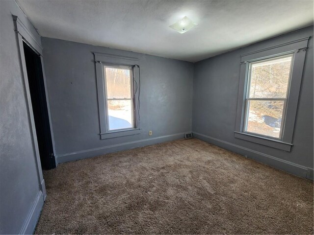 empty room with dark carpet