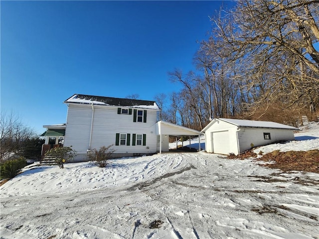 view of front of house featuring an outbuilding, a carport, and a garage