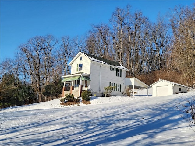 view of front of property with an outbuilding, a garage, and a porch