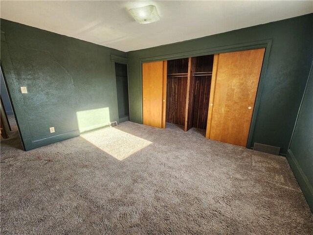 unfurnished bedroom featuring a closet and carpet