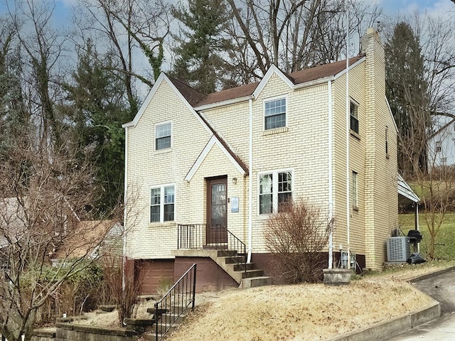 view of front of property with cooling unit and a garage