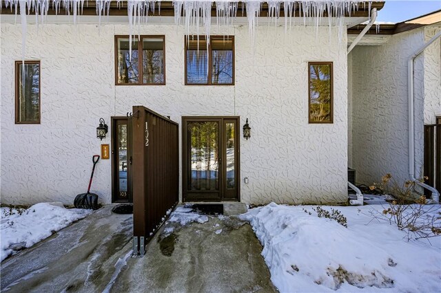 view of snow covered property entrance