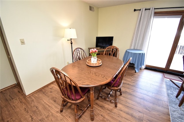 dining space featuring hardwood / wood-style floors