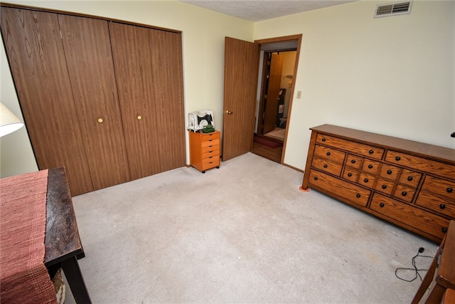 carpeted bedroom with a closet