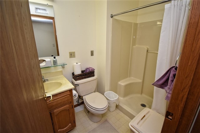 bathroom featuring vanity, toilet, and a shower with shower curtain