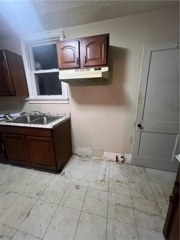 kitchen with sink and dark brown cabinets