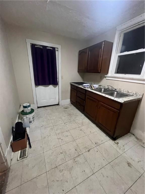 kitchen with dark brown cabinetry and sink