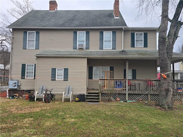 back of property featuring cooling unit, a wooden deck, and a yard