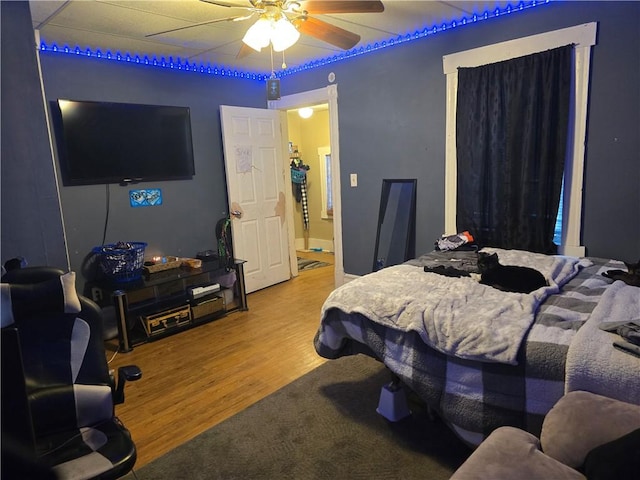 bedroom with hardwood / wood-style flooring and ceiling fan