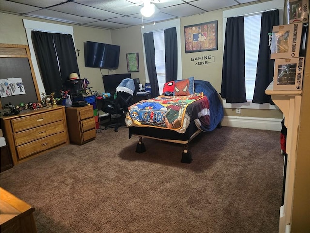 bedroom featuring a paneled ceiling, ceiling fan, and carpet