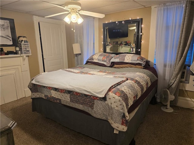 carpeted bedroom with a drop ceiling and ceiling fan