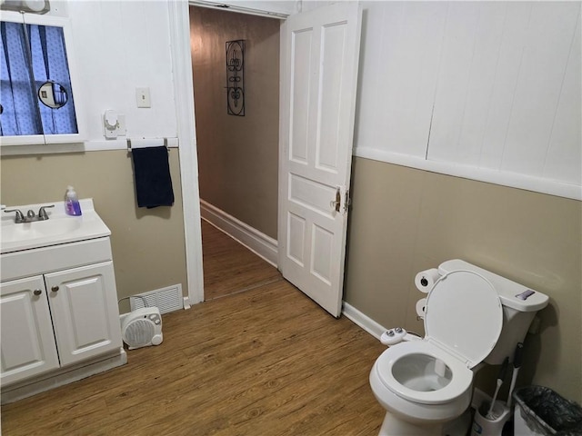 bathroom featuring hardwood / wood-style flooring, vanity, and toilet