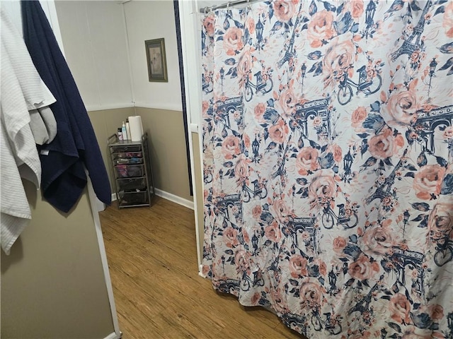 bathroom with hardwood / wood-style floors and walk in shower