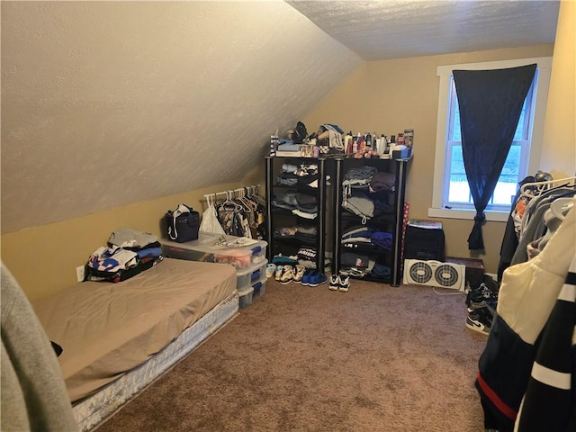 bedroom featuring lofted ceiling, a textured ceiling, and carpet flooring