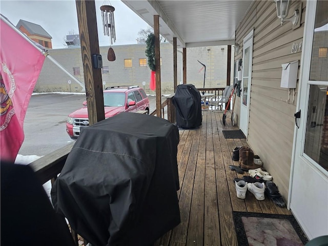 wooden terrace featuring a porch and grilling area