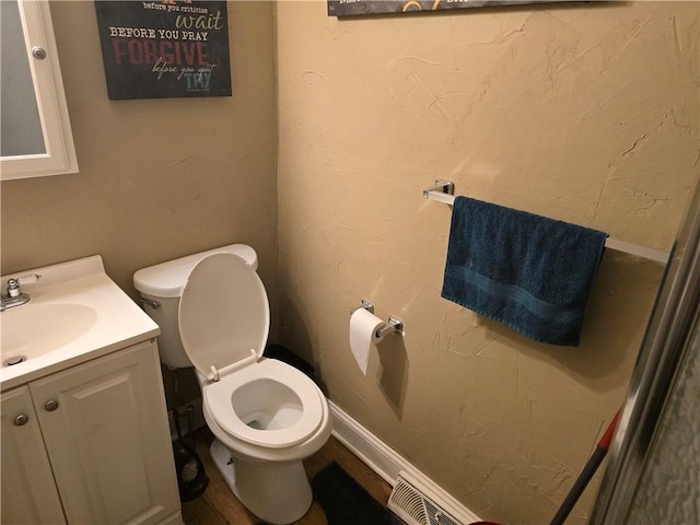 bathroom featuring vanity, wood-type flooring, and toilet