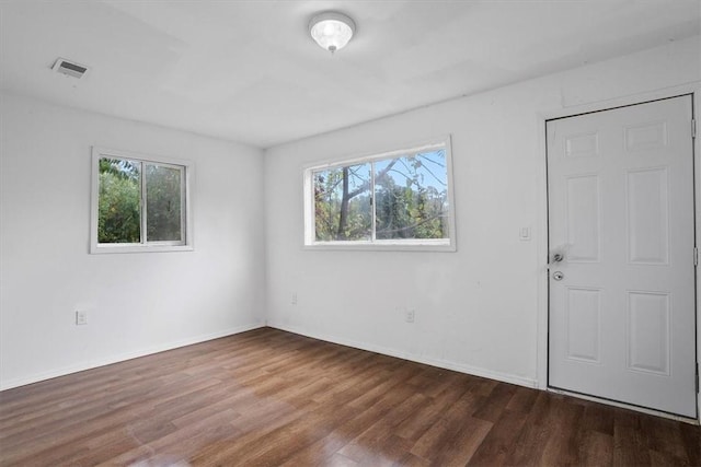 empty room featuring dark wood-type flooring