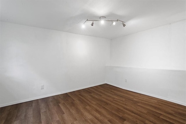 unfurnished room featuring dark hardwood / wood-style flooring