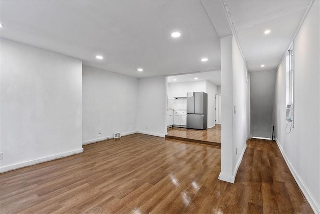 unfurnished living room featuring hardwood / wood-style floors