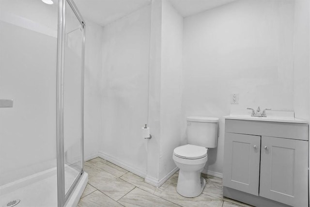 bathroom featuring vanity, an enclosed shower, and toilet