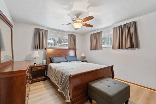 bedroom with ceiling fan and light hardwood / wood-style flooring