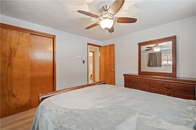 bedroom with a closet, ceiling fan, and light hardwood / wood-style flooring