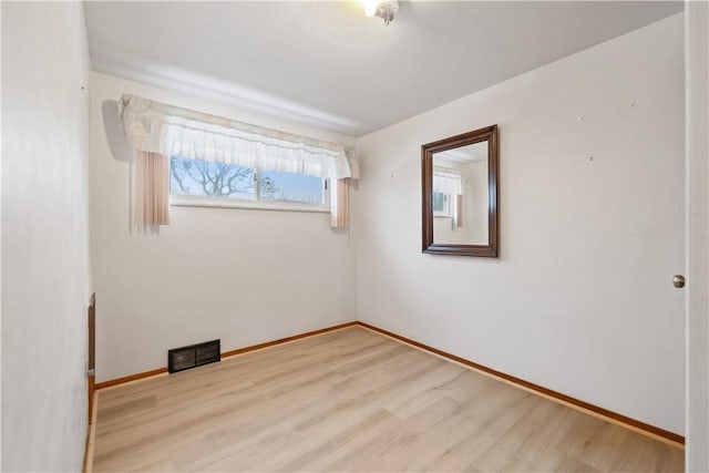 spare room featuring light hardwood / wood-style floors