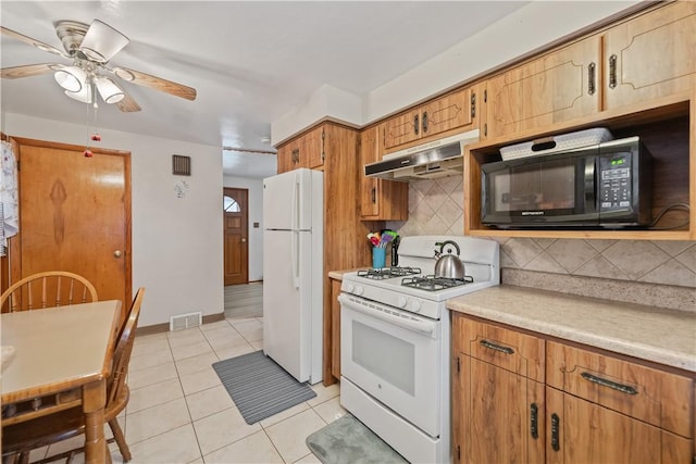 kitchen with ceiling fan, light tile patterned floors, backsplash, and white appliances