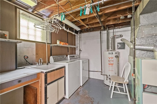 clothes washing area with gas water heater and separate washer and dryer